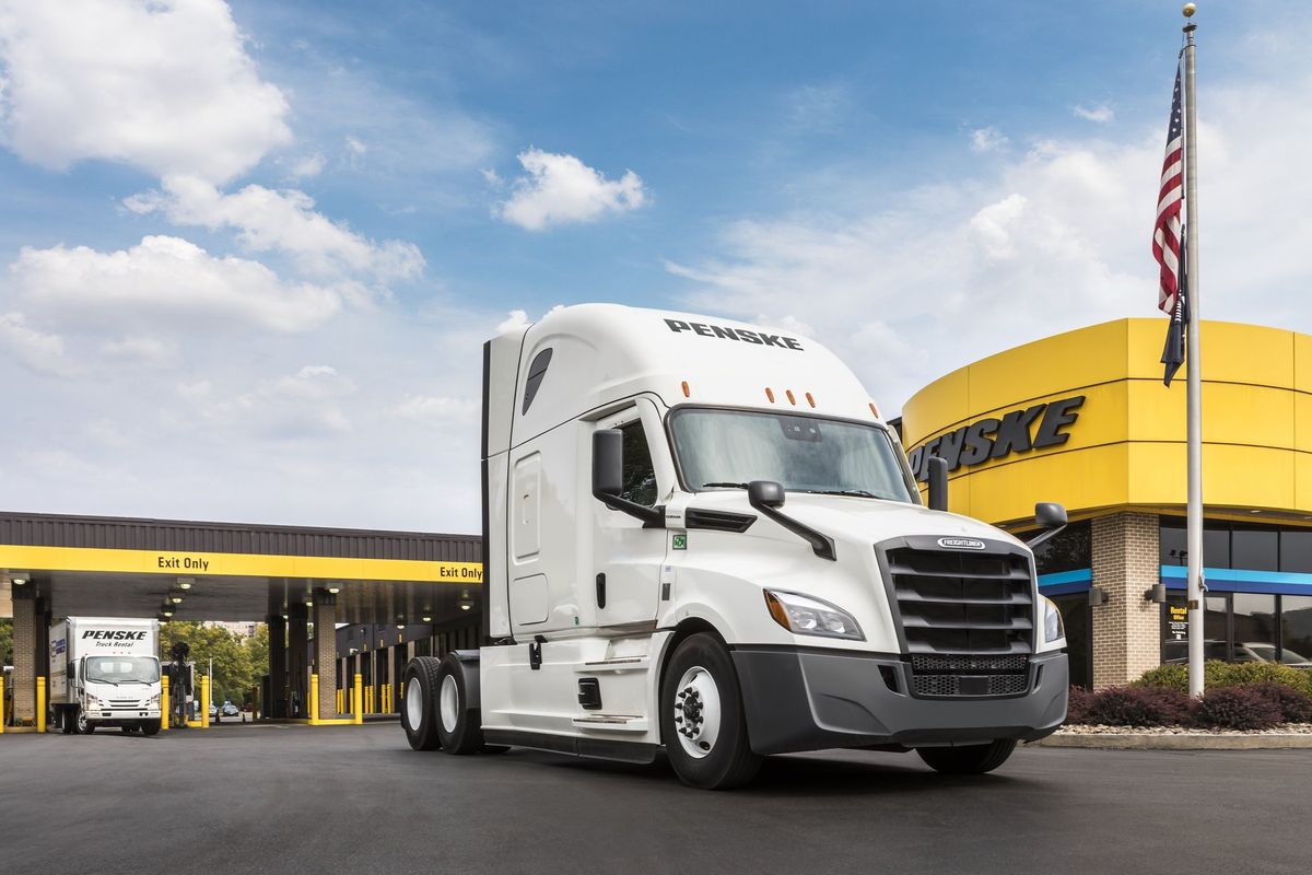 Trucks in front of a Penske building